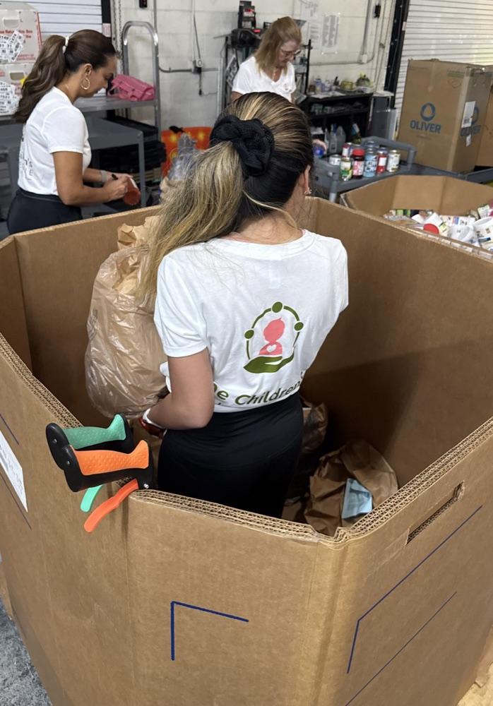 Board members in CCOF shirts sorting donated goods into large boxes